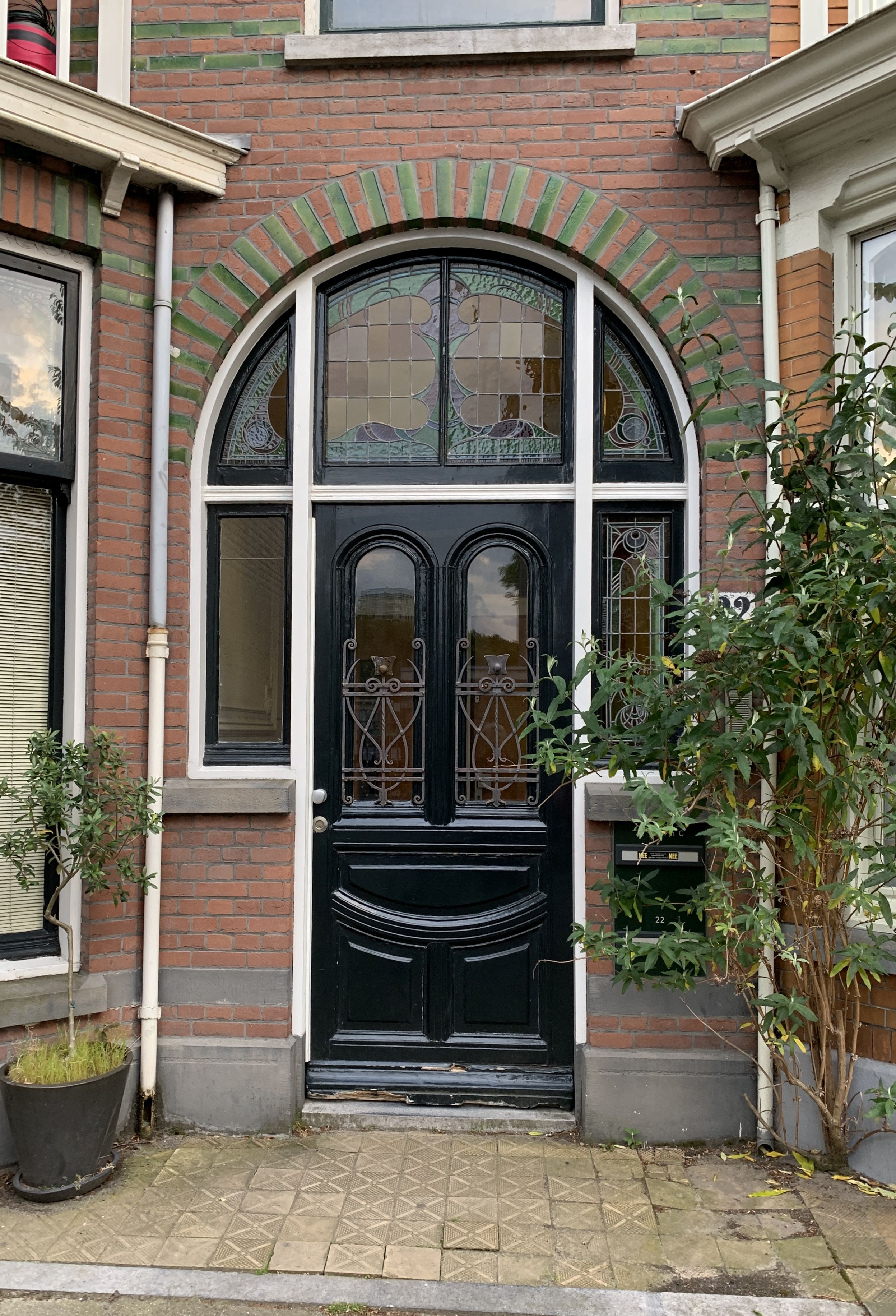 Door with arched stained glass around it