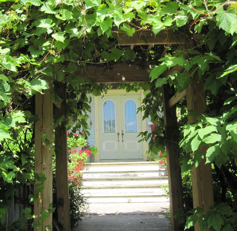 Doorway viewed througha grape arbor